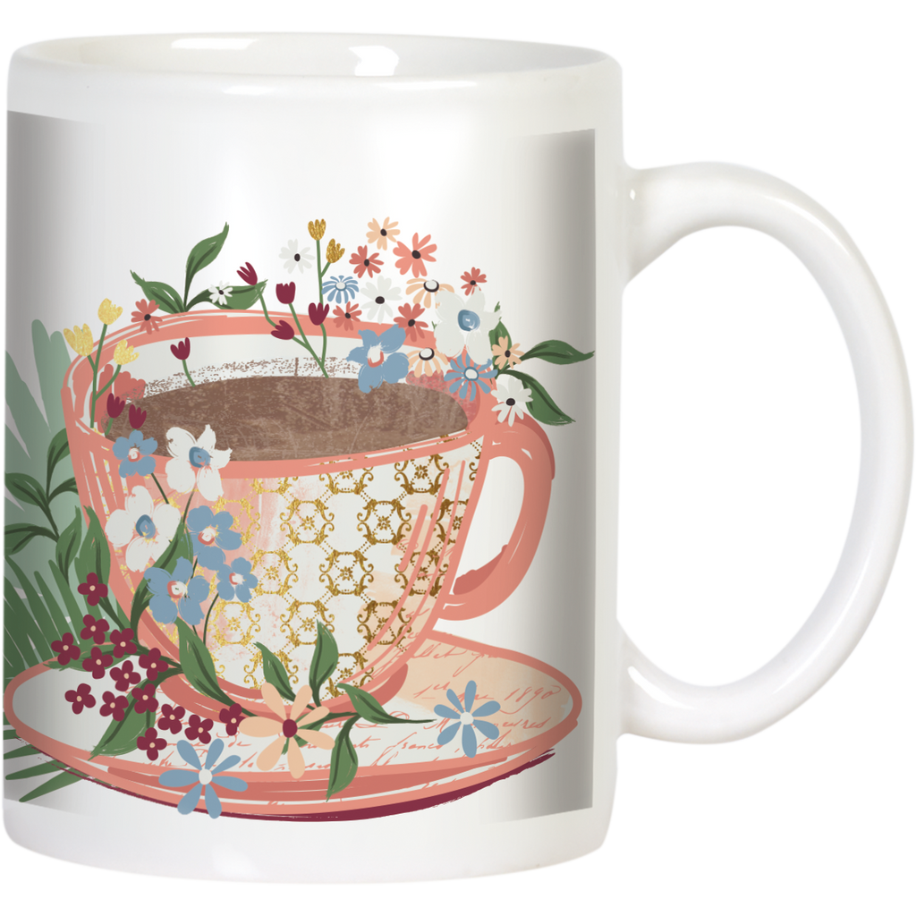 Front view of a white ceramic coffee mug featuring a vibrant floral design wrapping around a pink and gold patterned teacup graphic filled with a dark beverage, suitable for tea or coffee lovers.