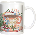Front view of a white ceramic coffee mug featuring a vibrant floral design wrapping around a pink and gold patterned teacup graphic filled with a dark beverage, suitable for tea or coffee lovers.