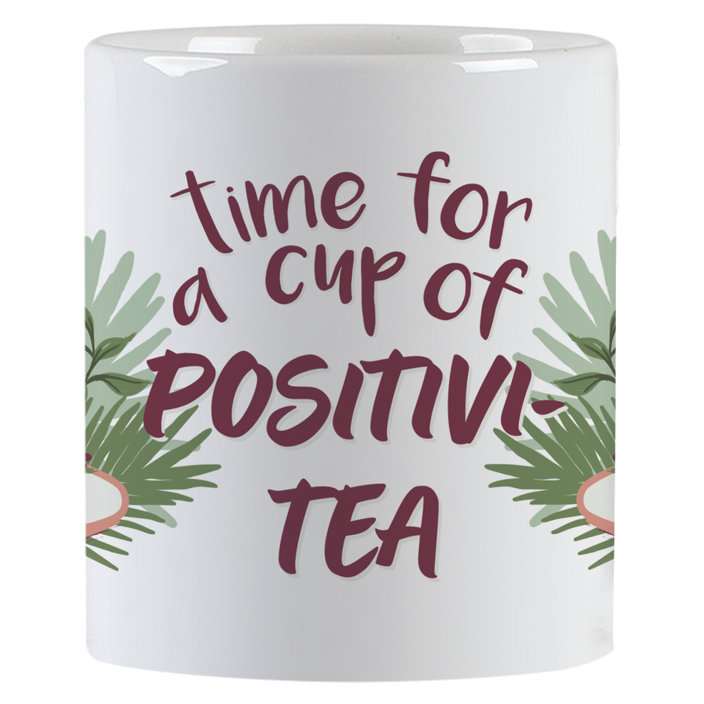 Side view of a ceramic mug with green leaf accents and the inspiring text 'time for a cup of POSITIVI-TEA' in purple script.