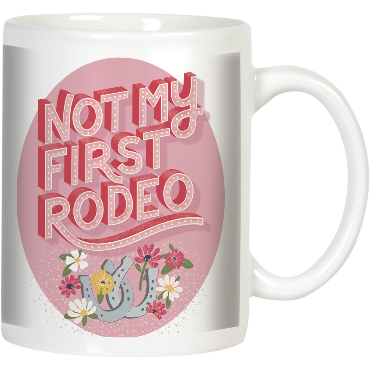 Front view of a white ceramic coffee mug featuring the sassy phrase 'Not My First Rodeo' in bold, distressed red 3D text on a pink circular background. The design includes gray horseshoes and colorful wildflowers like daisies and poppies at the bottom.