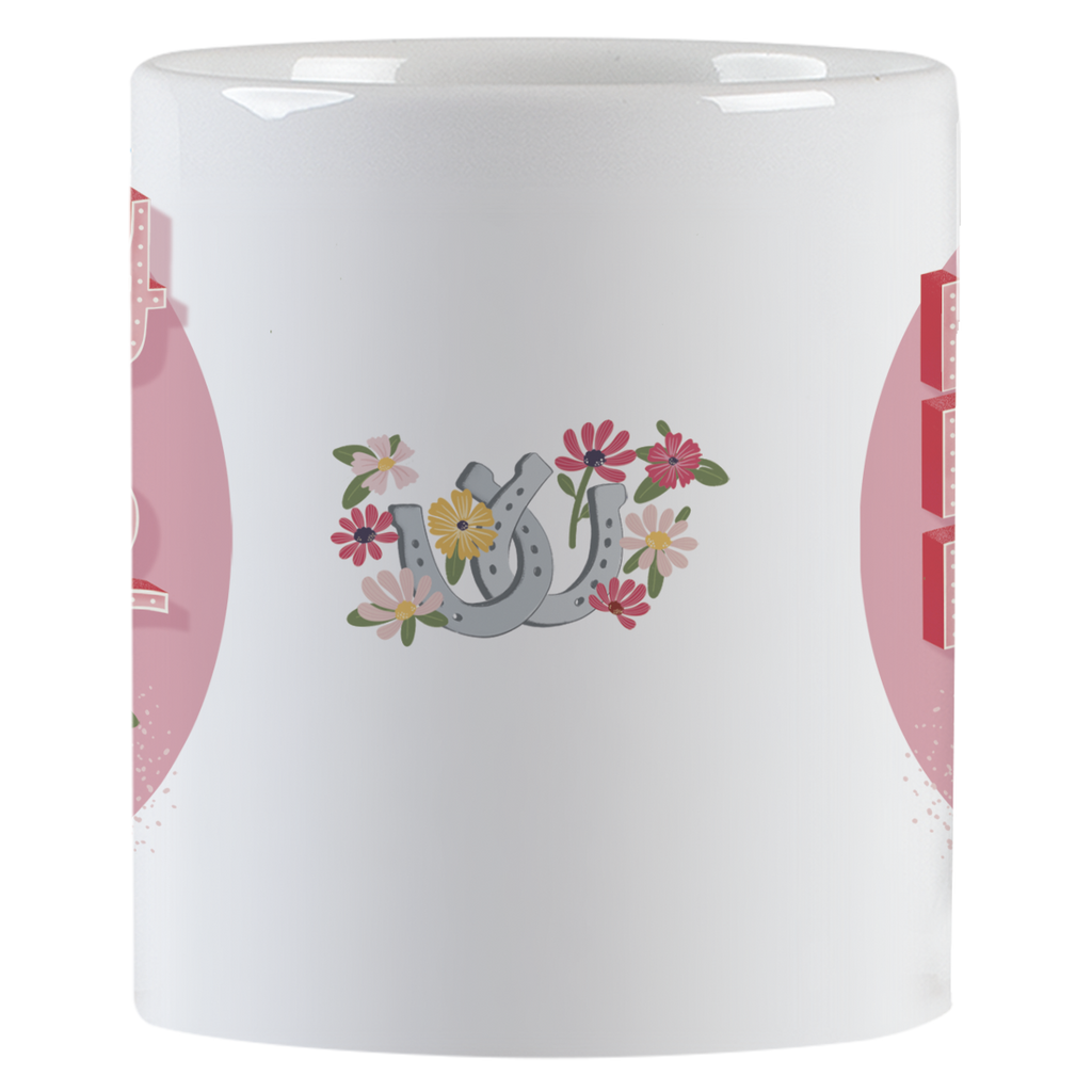Side view of a white ceramic mug, showcasing a vibrant design of grey horseshoes surrounded by an array of pink, yellow, and white flowers, set against a subtle pink background.