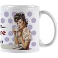 White ceramic mug featuring a retro pin-up woman with curly dark hair and red lipstick, elegantly sipping coffee from a small cup. The background has light purple polka dots.