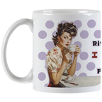 Angled view of a humorous ceramic mug showing a vintage-style woman enjoying her coffee, with the 'I don't rise and shine...' quote partially visible on the side.