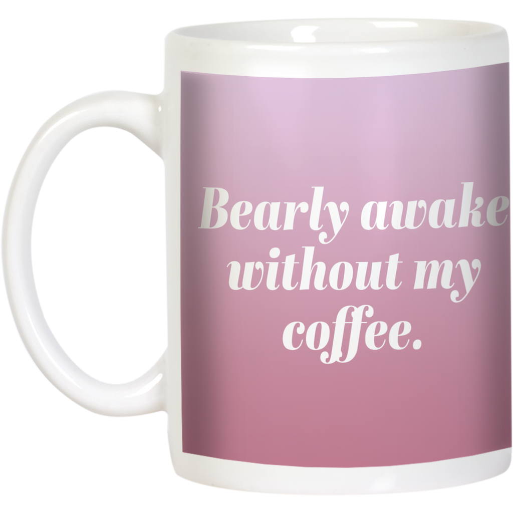 White ceramic coffee mug with 'Bearly awake without my coffee' text in elegant white font on a soft pink background, ideal funny coffee lover gift.