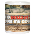 Side view of a white ceramic mug, showing the humorous "NO BULLS#!T BEFORE MY COFFEE!" text in bold red and white letters on a blurred ranch fence background. Ideal for a witty gift.