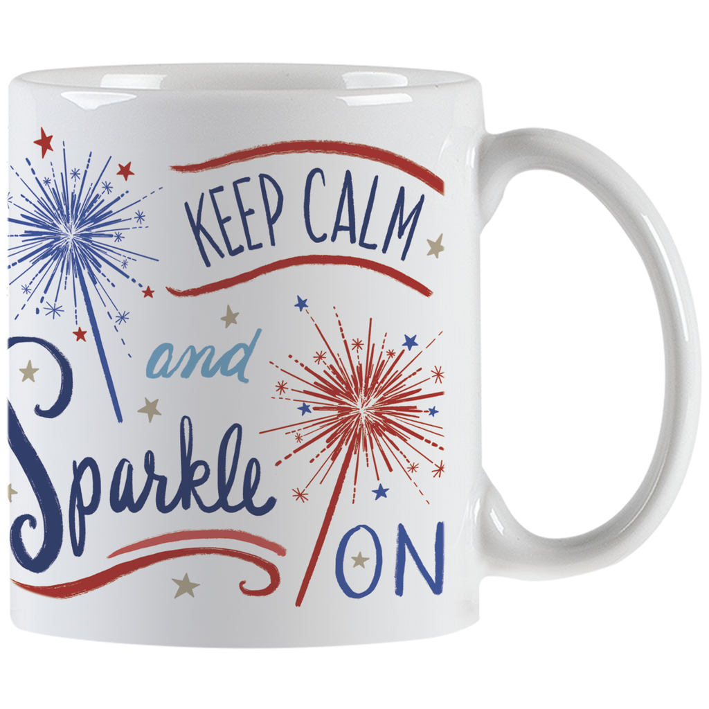 White ceramic mug with 'Keep Calm and Sparkle ON' typography and red and blue sparkler illustrations, showing the handle.