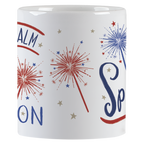 Close-up view of a white ceramic mug, showing red and blue sparkler graphics and parts of the 'Keep Calm and Sparkle ON' text.