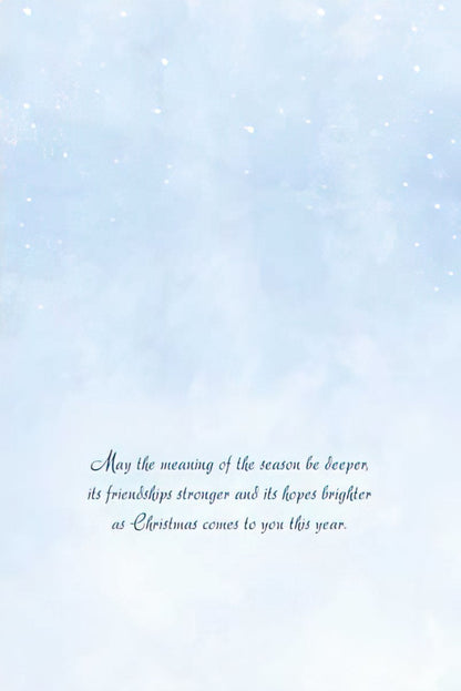 Inside of a Christmas greeting card with a light blue sky background and white speckles, featuring a heartfelt holiday message.