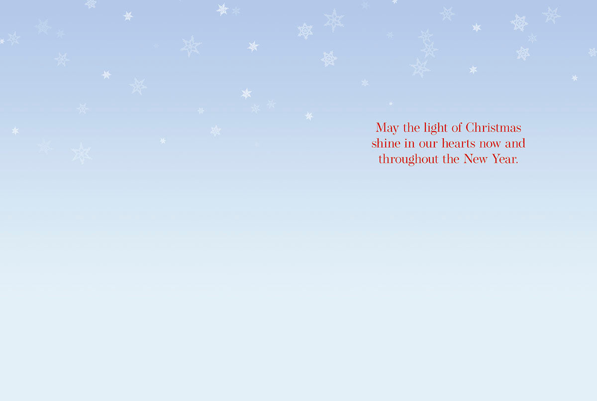 Inside of a Christmas greeting card with a heartfelt message: 'May the light of Christmas shine in our hearts now and throughout the New Year.'