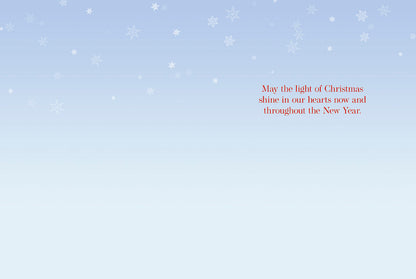 Inside of a Christmas greeting card with a heartfelt message: 'May the light of Christmas shine in our hearts now and throughout the New Year.'