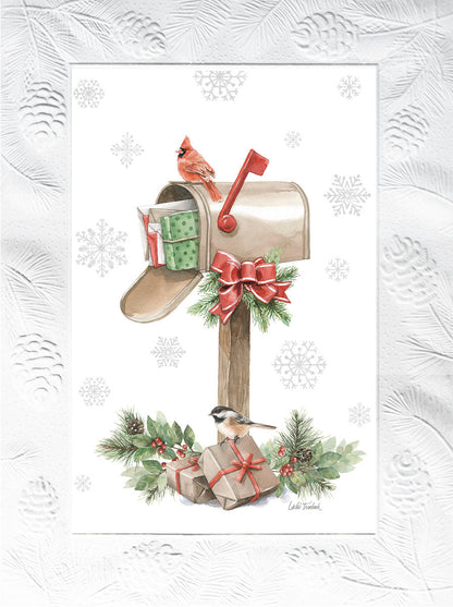 Christmas card with a vibrant red cardinal and a small chickadee on a decorated mailbox overflowing with presents, surrounded by snowflakes.