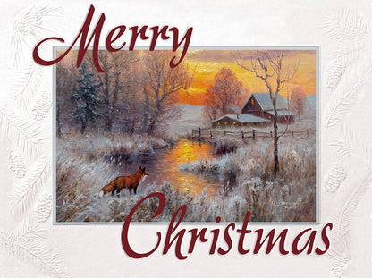 Christmas greeting card with a red fox standing by a snowy creek and a farm in the background during sunset.