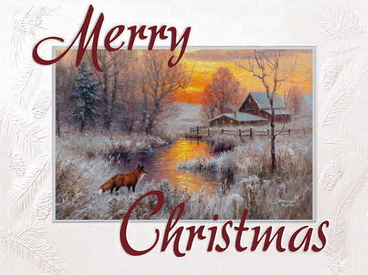 Christmas greeting card with a red fox standing by a snowy creek and a farm in the background during sunset.