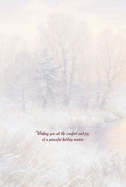 Inside of a Christmas greeting card with a serene snowy winter landscape and holiday message.
