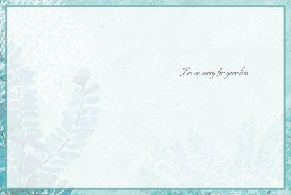 Inside of a peaceful sympathy card with subtle coral and leaf accents. Displays the comforting message: 'I'm so sorry for your loss.'