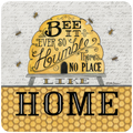 Home sweet home bee coaster featuring a yellow beehive, buzzing bees, and the quote 'Bee It Ever So Humble, There's No Place Like Home' on a honeycomb pattern background.