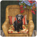 Adorable black Labrador puppy coaster, featuring a lab puppy on a wicker chair with floral cushions and hanging flowers, ideal for dog lovers and pet enthusiasts.