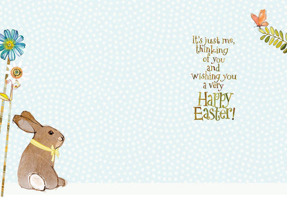 Inside of cute Easter card with sitting bunny and message "Happy Easter!" on a light blue polka dot background.
