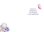 Inside of an Easter card with a white background. The message reads 'It's just me, thinking of you and wishing you a very Happy Easter!' in purple script, accompanied by a small pink butterfly icon. The bottom left corner shows a glimpse of the bunny and flowers from the front design.