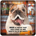 Close-up of a happy bulldog with a foamy mouth, tongue out, next to a full mug of frothy beer, with the text 'BEER IS PROOF THAT GOD LOVES US AND WANTS US TO BE HAPPY.' in front of a blurred bar background. Ideal for beer lovers, dog owners, and funny drinkware.