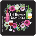 Round coaster with 'Life Happens Wine Helps' text in white script, encircled by a vibrant watercolor floral wreath with pink and white flowers, green leaves, and small purple blossoms. Features a pink watercolor wine bottle and a red wine glass on the left, and a green watercolor wine bottle with a white wine glass on the right, all on a black background. Ideal for wine enthusiasts.