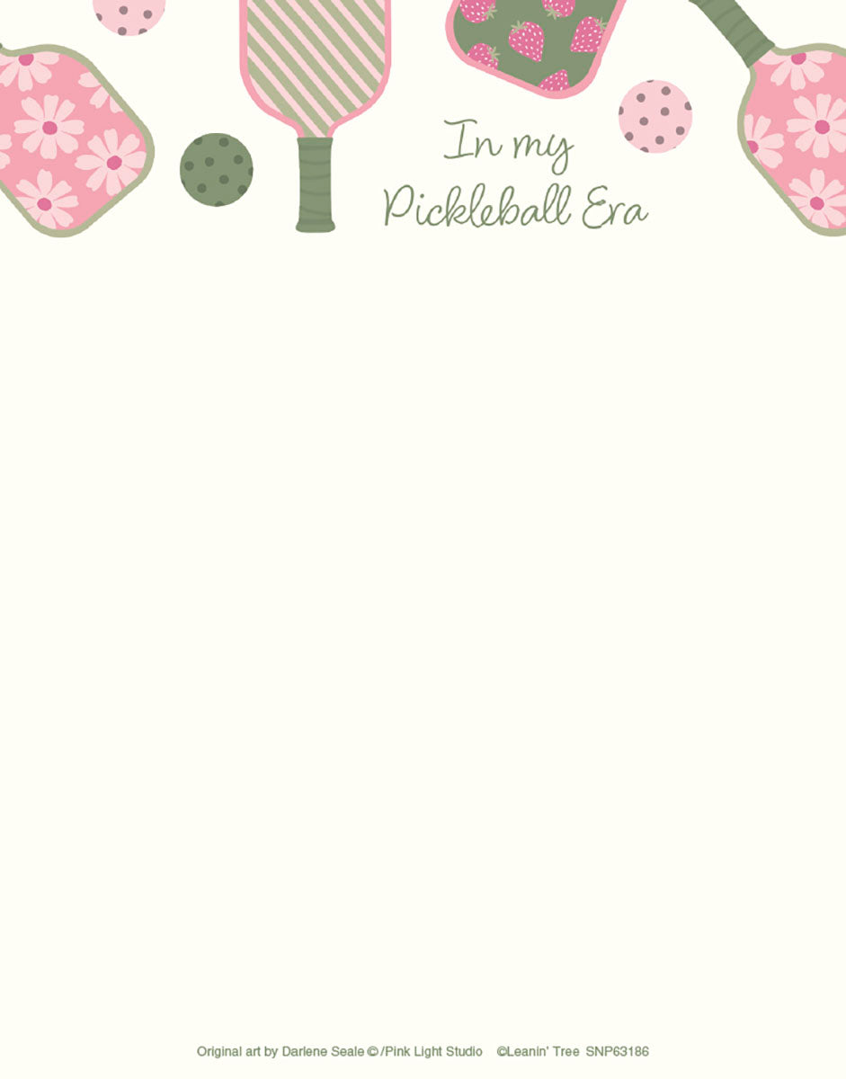 An SEO-optimized alt description for a light beige notepad. The top border features pink and green pickleball paddles, some with floral daisy patterns, others with strawberry designs. Dotted pickleballs are interspersed among the paddles. The central text reads 'In my Pickleball Era' in a decorative script. This design is perfect for pickleball players, fans, and anyone looking for fun, themed stationery.