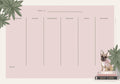 A pink weekly desk calendar with a charming French Bulldog illustration, tropical leaves, and designated space for notes. The dog, wearing a pink bow, sits on a stack of books titled "Dare to Dream", "Fashion & Style", and "Self Care".