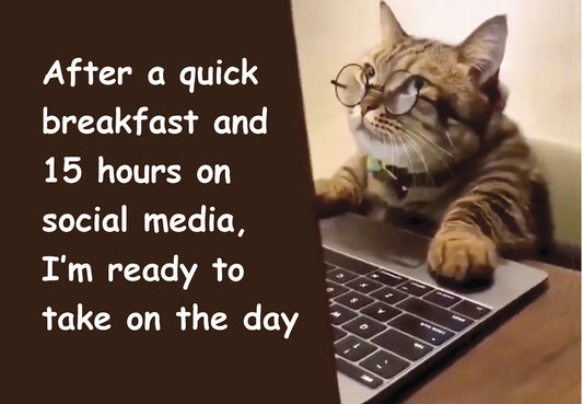 Funny cat wearing glasses typing on a laptop with the quote 'After a quick breakfast and 15 hours on social media, I'm ready to take on the day'.