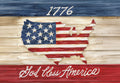 Distressed wooden patriotic magnet featuring the map of the United States filled with the American flag, the year '1776' above, and 'God Bless America' below, all against a rustic wood-grain background in red, white, and blue tones, ideal for fridge decor.