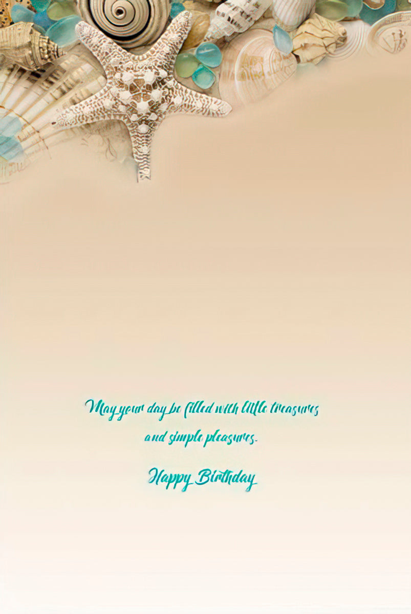 Inside a birthday greeting card with seashell design border and 'May your day be filled with little treasures... Happy Birthday' text.