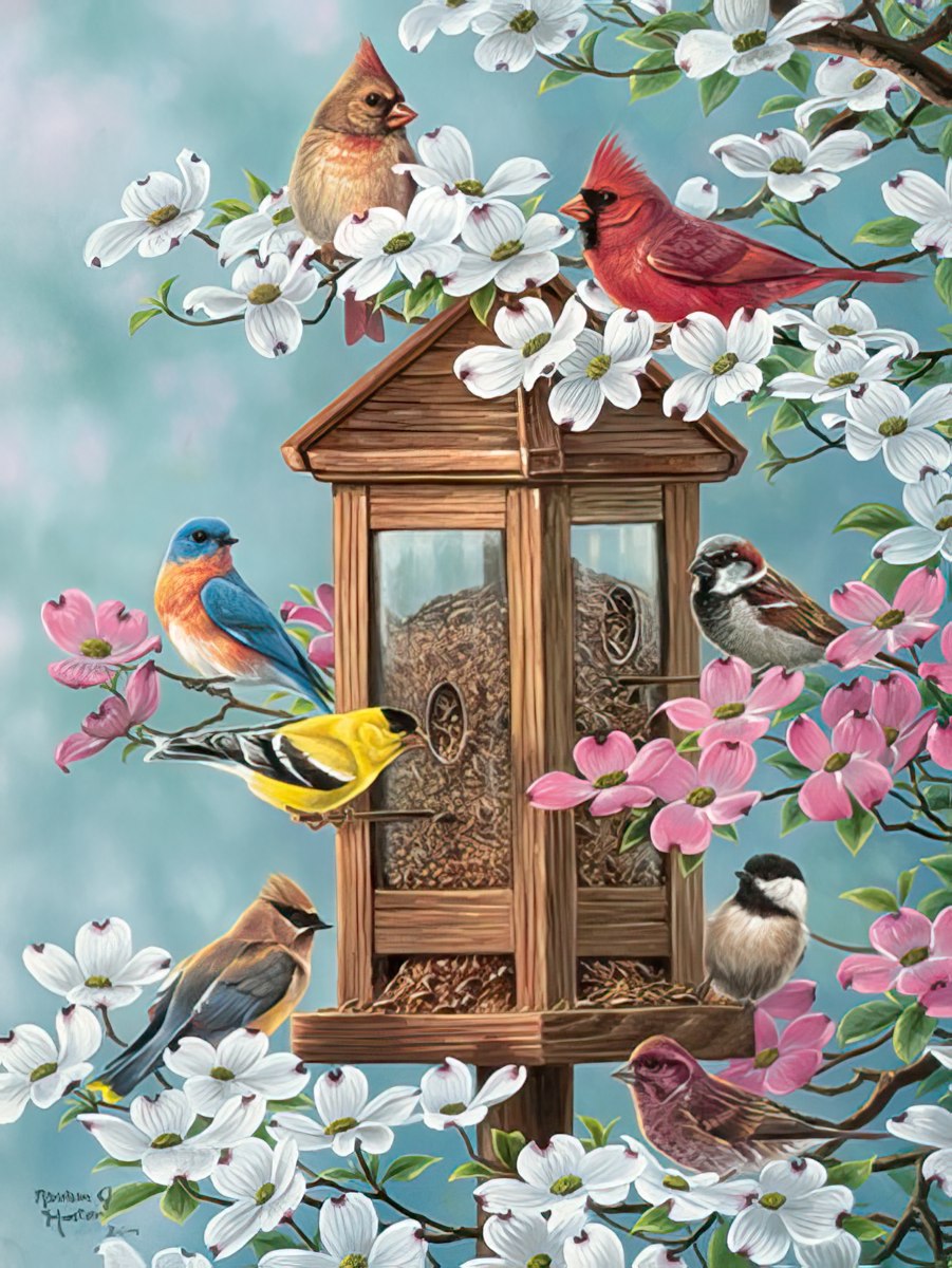 A diverse group of birds, including cardinals and finches, perches on a bird feeder surrounded by beautiful white and pink dogwood blossoms.