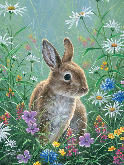 A charming baby rabbit sits among a vibrant array of white, blue, and purple wildflowers in a lush green meadow.