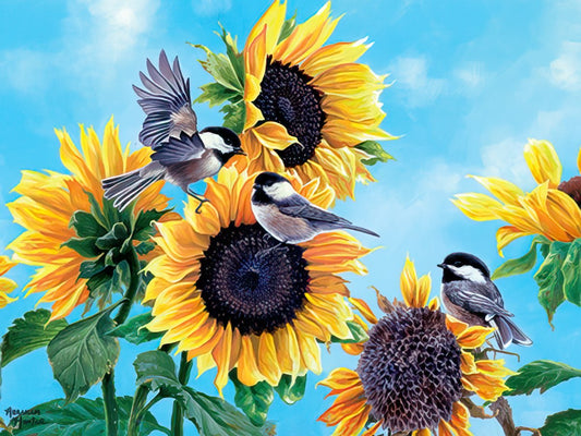 Three black-capped chickadees perched among vibrant yellow sunflowers against a bright blue sky, conveying warmth and gratitude.