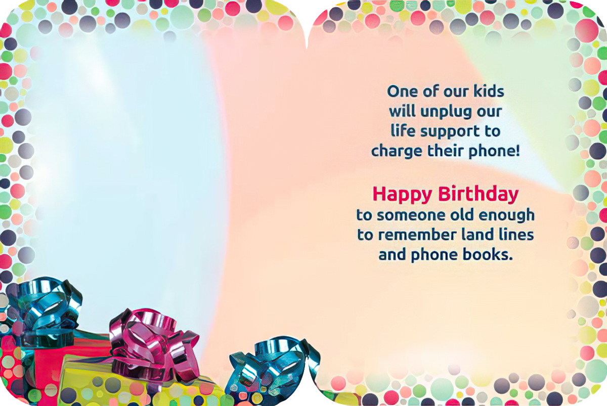 Open sassy birthday greeting card showing the interior text: 'One of our kids will unplug our life support to charge their phone! Happy Birthday to someone old enough to remember land lines and phone books.' Decorated with bright polka dots and gift boxes.