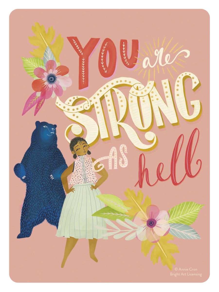 Empowering vinyl sticker featuring a confident woman with hands on hips and a determined expression, standing next to a large blue bear, all set against a vibrant pink background. The design is adorned with colorful floral and leaf motifs, and bold white text reads 'You are STRONG AS HELL'. This inspirational art piece celebrates female resilience and inner power, designed by Annie Cron.