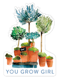 Watercolor art sticker featuring a collection of potted green and blue trees and plants, with a small black sign saying 'love' and the empowering text 'YOU GROW GIRL' beneath. Perfect for plant lovers, gardeners, and those seeking inspiration.