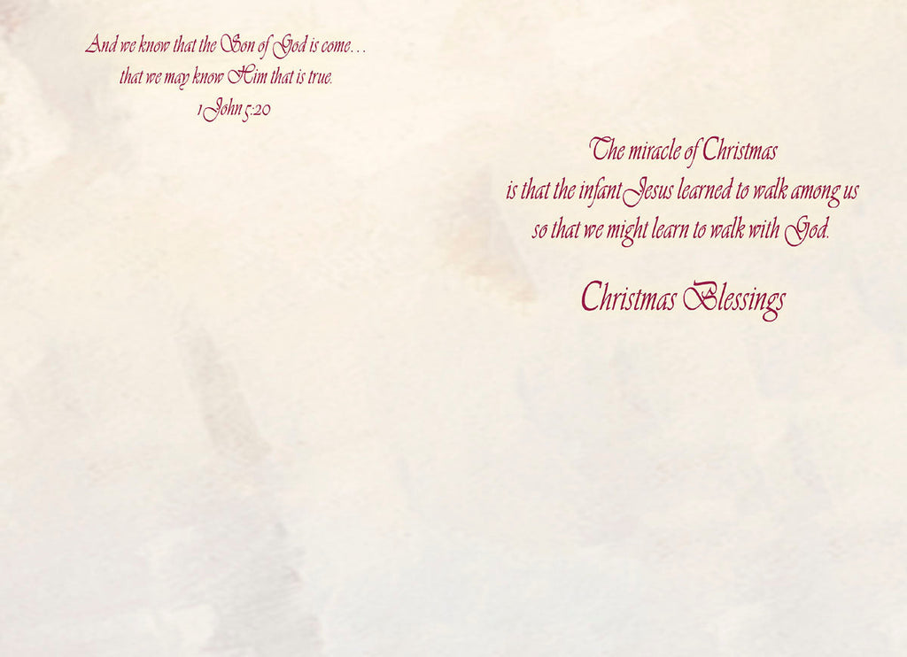 Inside of a religious greeting card showing scriptural text from 1 John 5:20 and a heartfelt message about Jesus's journey enabling us to walk with God, concluding with 'Christmas Blessings'.