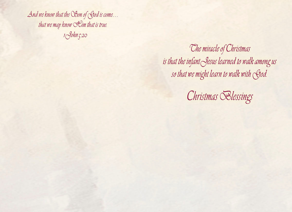 Inside of a religious greeting card showing scriptural text from 1 John 5:20 and a heartfelt message about Jesus's journey enabling us to walk with God, concluding with 'Christmas Blessings'.