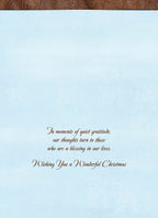 Inside view of a greeting card with elegant script text: 'In moments of quiet gratitude, our thoughts turn to those who are a blessing in our lives. Wishing You a Wonderful Christmas.' on a soft blue background.