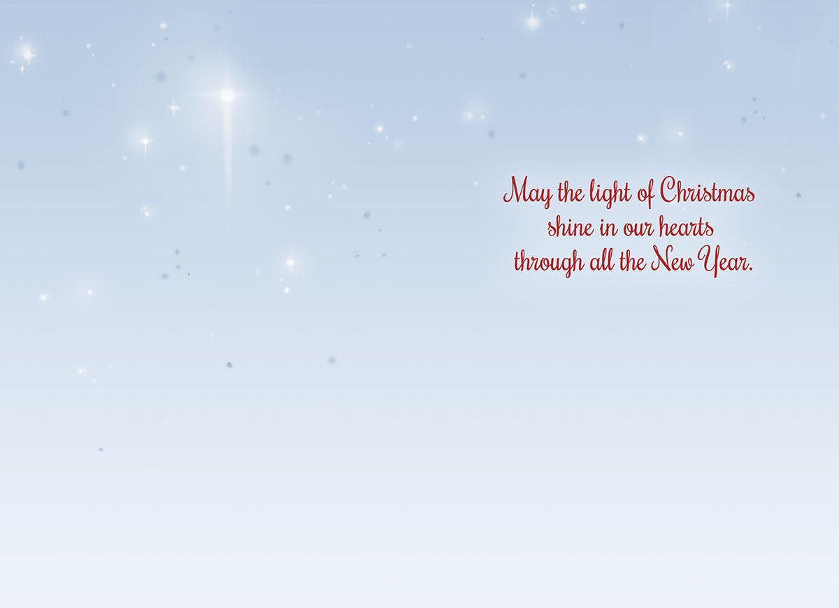 Interior of a religious holiday card with sparkling blue background and heartfelt message 'May the light of Christmas shine in our hearts through all the New Year.'