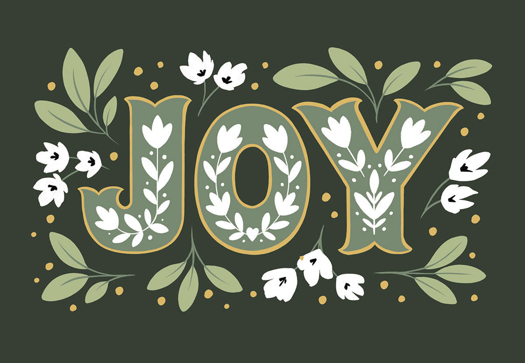 Front of a deep forest green holiday greeting card featuring large, decorative gold-outlined letters spelling "JOY" adorned with white flowers and green leaves, surrounded by small floral accents.