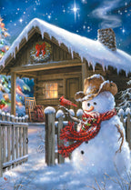 Front of a charming holiday greeting card featuring a friendly snowman in a cowboy hat and red scarf, with a cardinal perched on his arm. He stands by a rustic fence in front of a cozy log cabin, adorned with a wreath, under a starlit, snowy winter sky.