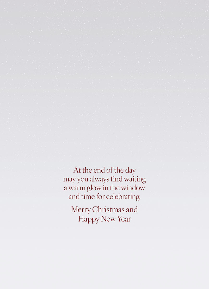 SEO optimized alt description: The interior of a heartfelt greeting card displaying a message in elegant red script against a lightly speckled grey background. The text reads: 'At the end of the day may you always find waiting a warm glow in the window and time for celebrating. Merry Christmas and Happy New Year'.