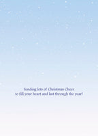 The inside of a heartwarming holiday greeting card featuring a light blue, subtly speckled background resembling falling snow, with the elegant message 'Sending lots of Christmas Cheer to fill your heart and last through the year!' centered on the page, ready to convey festive wishes.