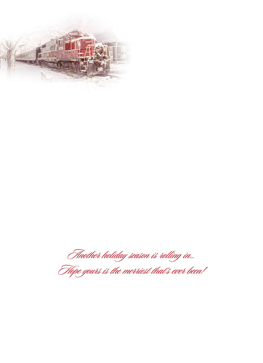 Inside view of a white greeting card featuring a faded image of a festive train at the top, with elegant red script text reading: 'Another holiday season is rolling in... Hope yours is the merriest that's ever been!'