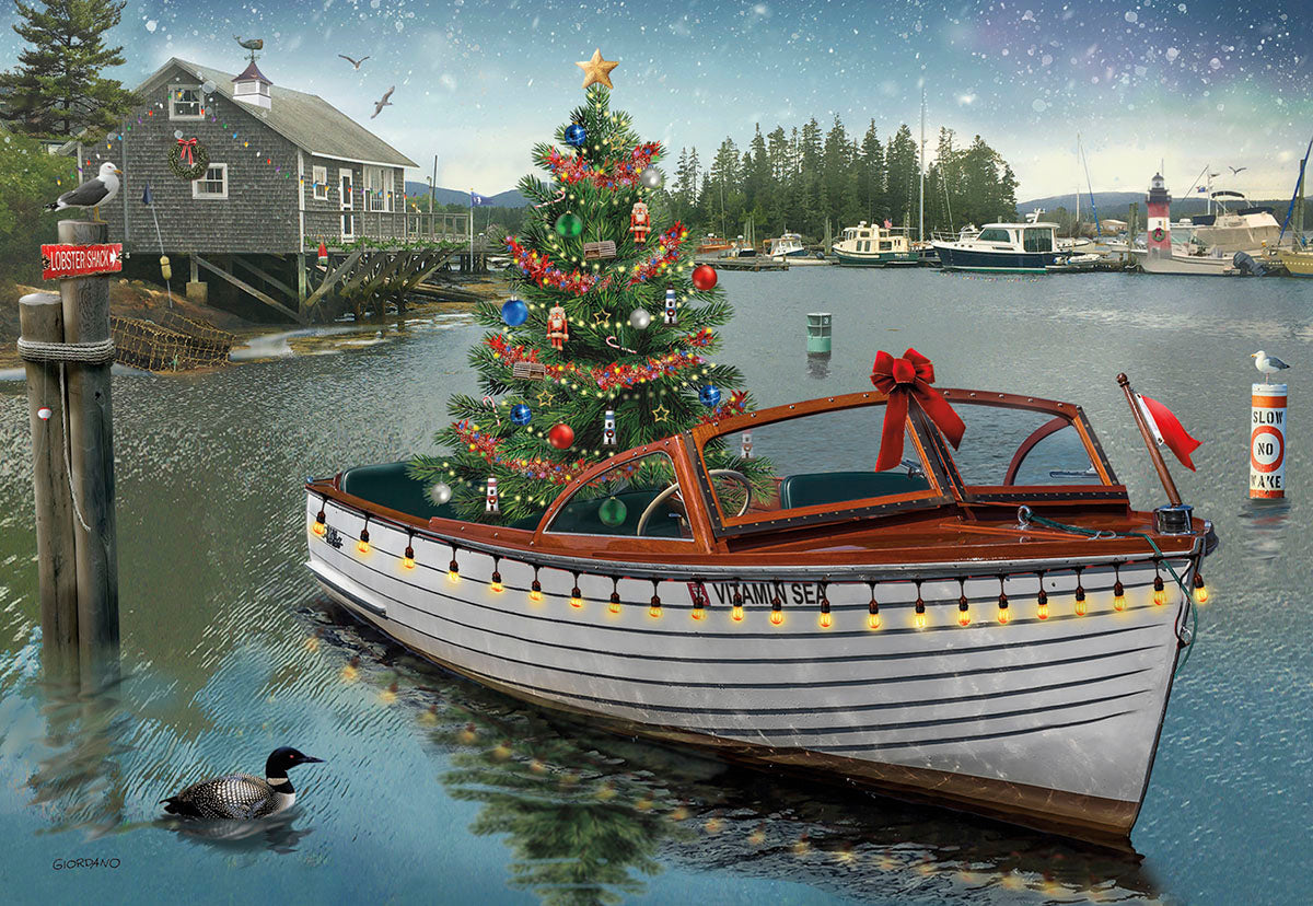 Scenic Christmas greeting card featuring a festive boat named 'Vitamin Sea' adorned with a decorated Christmas tree and string lights in a snowy coastal harbor with a dock, boathouse, and a loon.