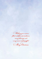 Inside of a greeting card with a soft blue background and red script text that reads: 'Wishing you a season filled with favorite traditions, many blessings, and every reason to feel joyful! Merry Christmas.'