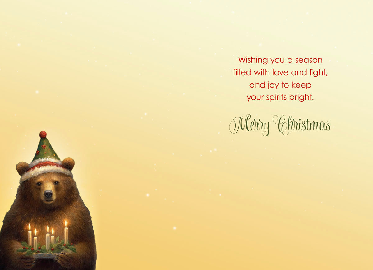 The inside of a heartwarming holiday card, showcasing a charming bear in a festive hat on the left, holding lit candles and holly, with a 'Wishing you a season filled with love and light, and joy to keep your spirits bright. Merry Christmas' message on the right.
