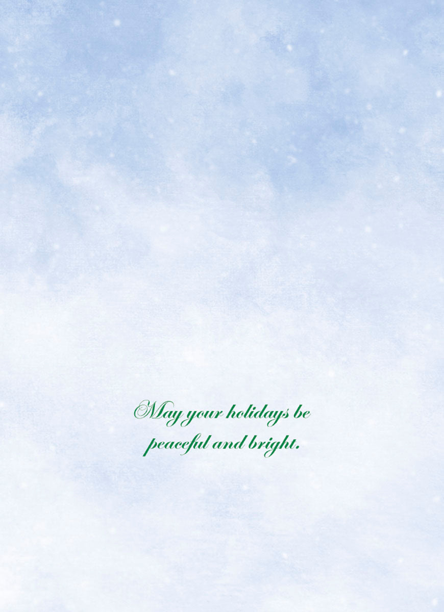 Inside of a holiday greeting card featuring a soft blue background with gently falling snow, displaying the heartfelt message: 'May your holidays be peaceful and bright.'