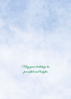 Inside of a holiday greeting card featuring a soft blue background with gently falling snow, displaying the heartfelt message: 'May your holidays be peaceful and bright.'